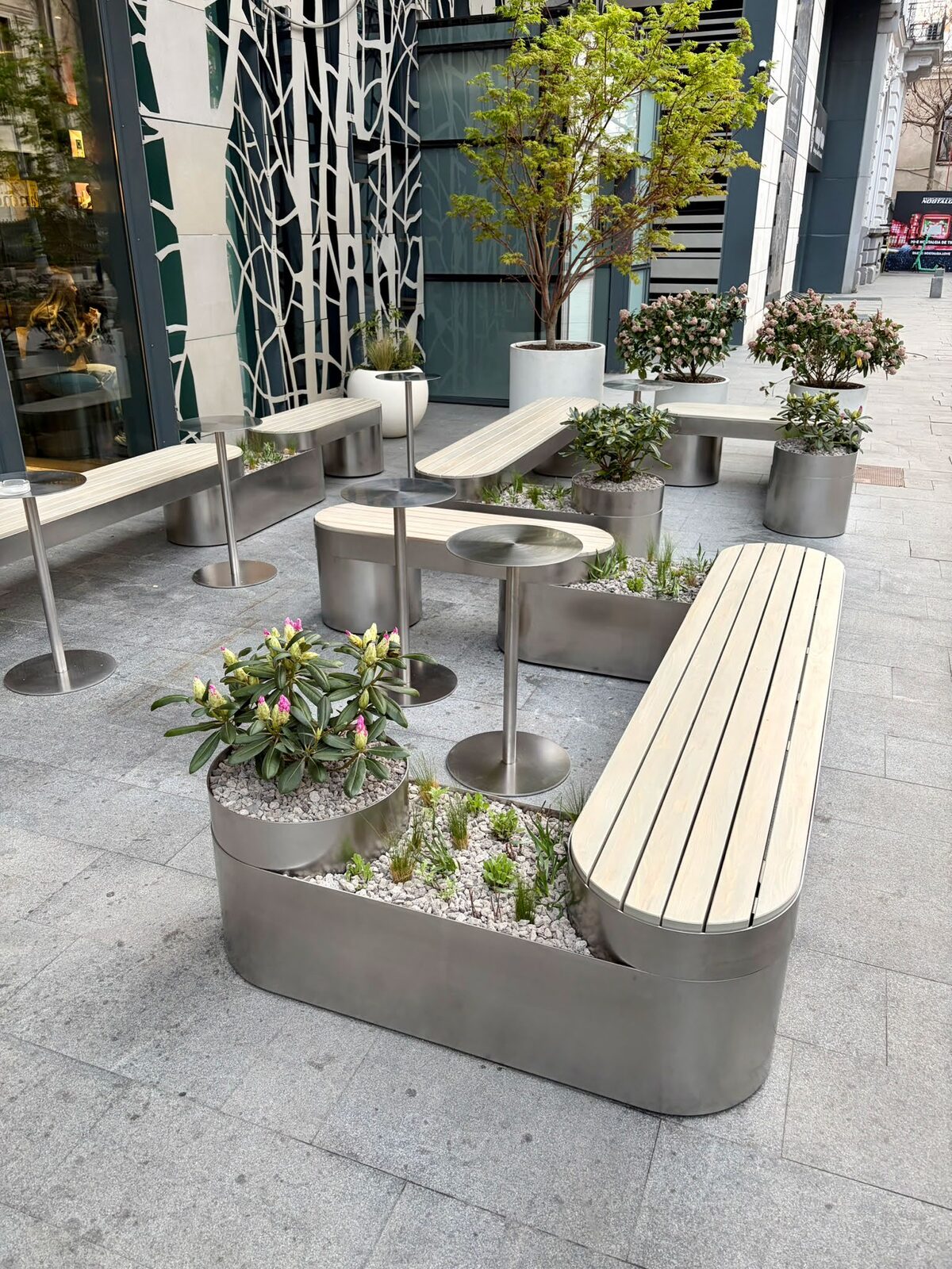 Stainless steel benches with timber seats and steel planters on the P9 Bakery terrace