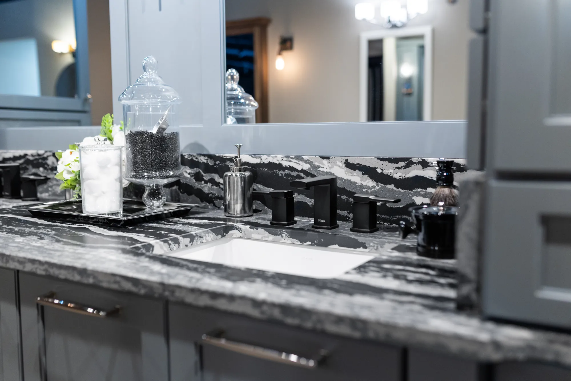Black and white stone countertop on a gray bathroom vanity
