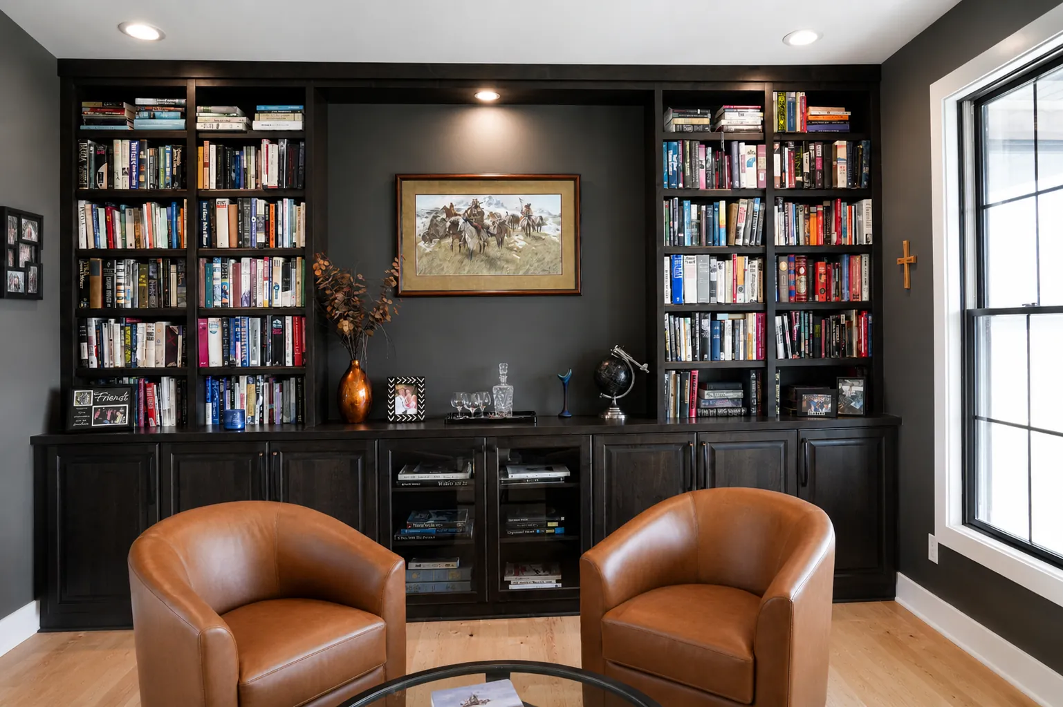 Floor-to-ceiling dark stained library built-ins in a home study