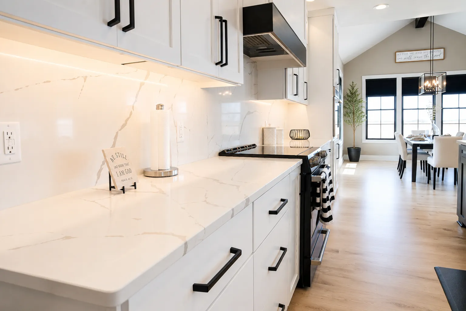 White shaker cabinets with a white quartz countertop and backsplash