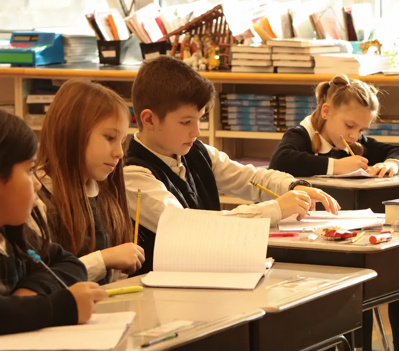 Young students working at their desks.