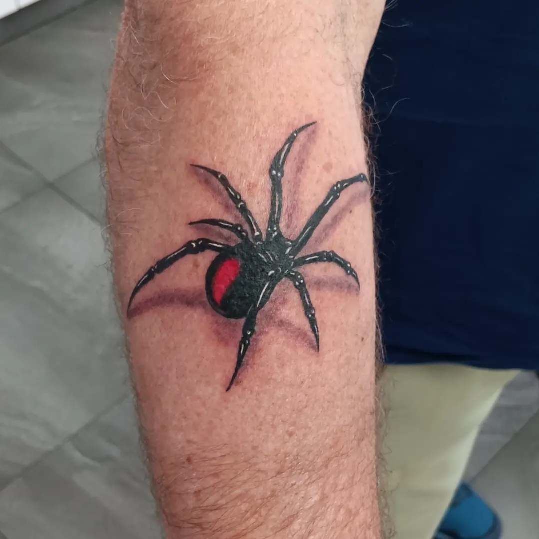 Black and red spider tattoo by Ramona at Lady Ink