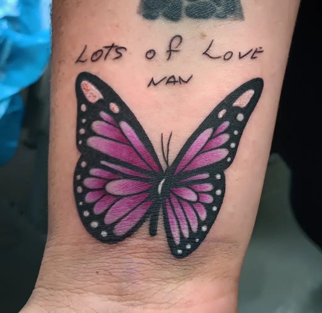 Purple butterfly memorial tattoo by Ramona at Lady Ink
