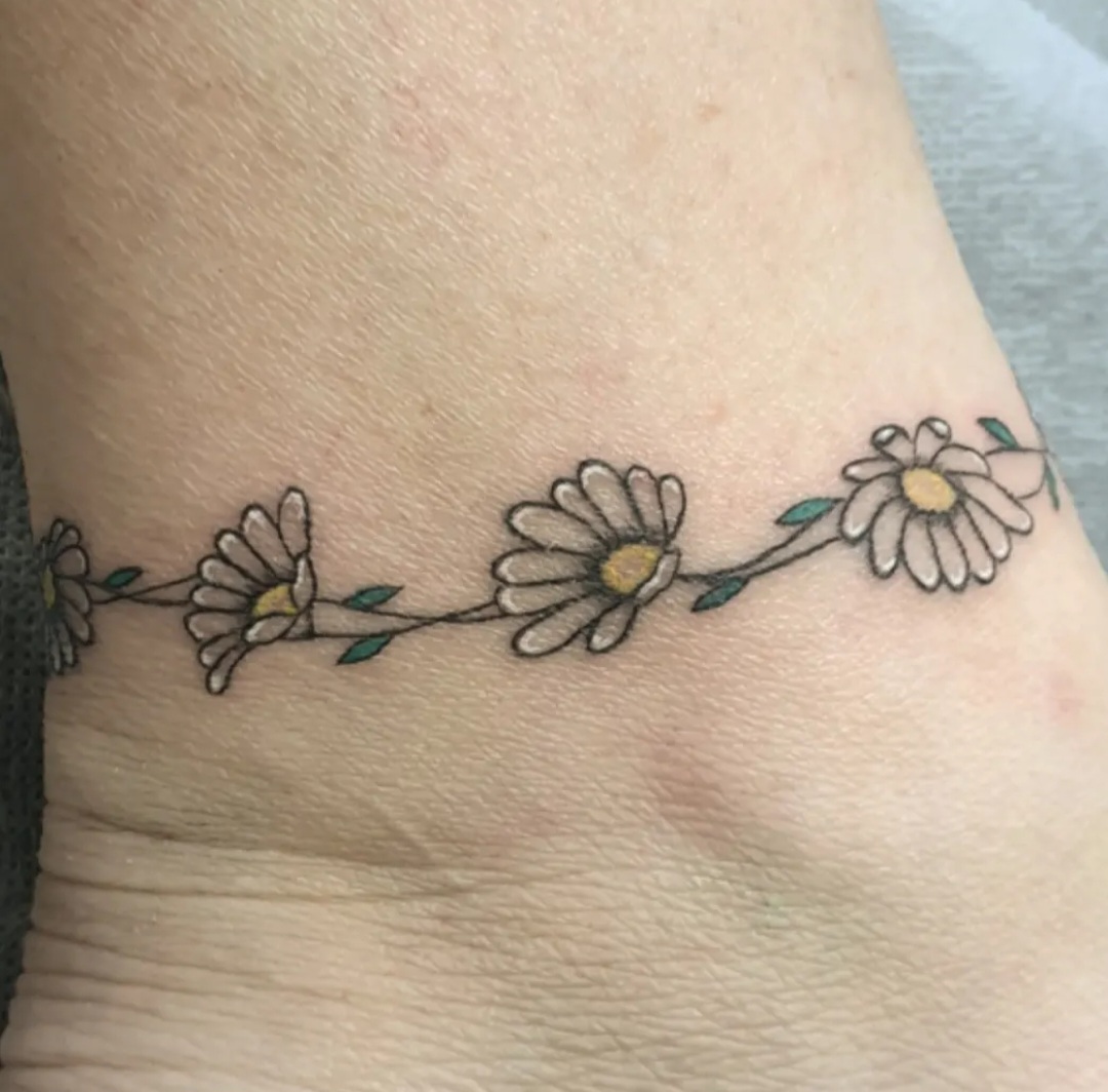 Daisy chain ankle tattoo by Ramona at Lady Ink