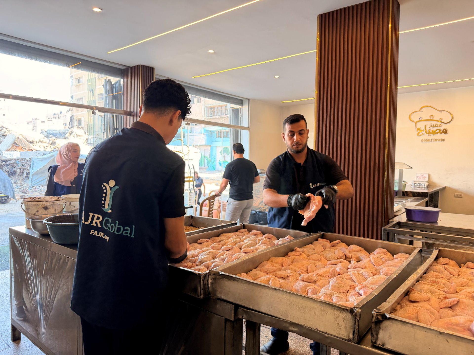 FAJR Global team preparing food amid the rubble in Gaza