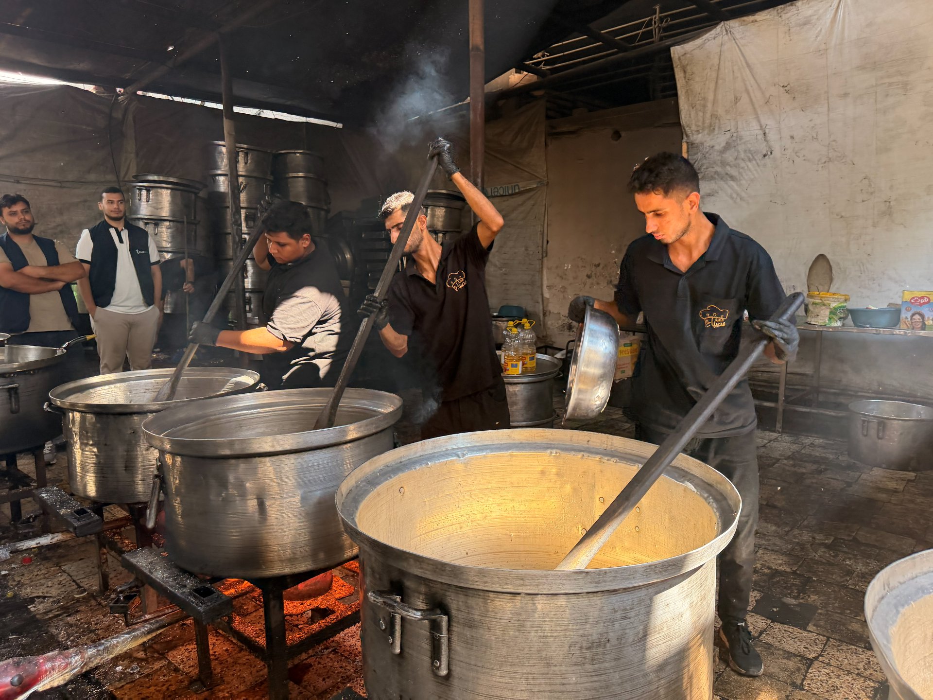 Cooking large pots of food for displaced families
