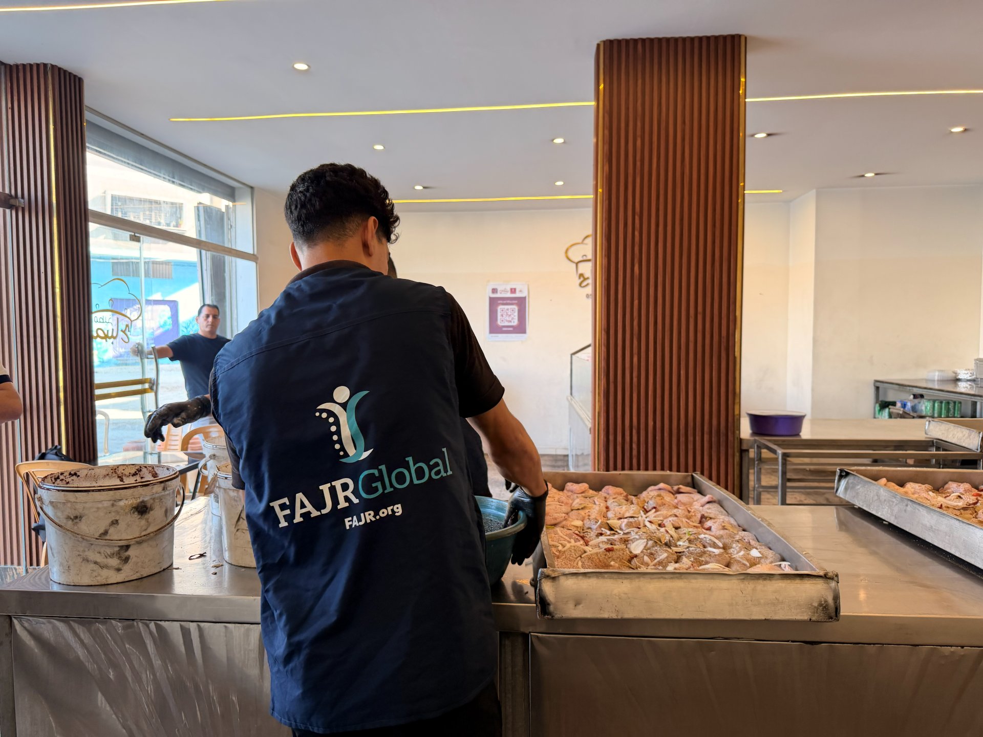 FAJR Global staff seasoning meals for distribution
