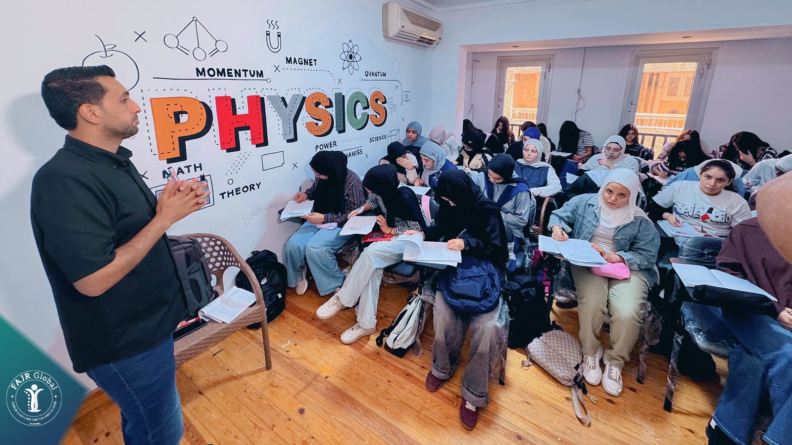 A teacher with a full physics class