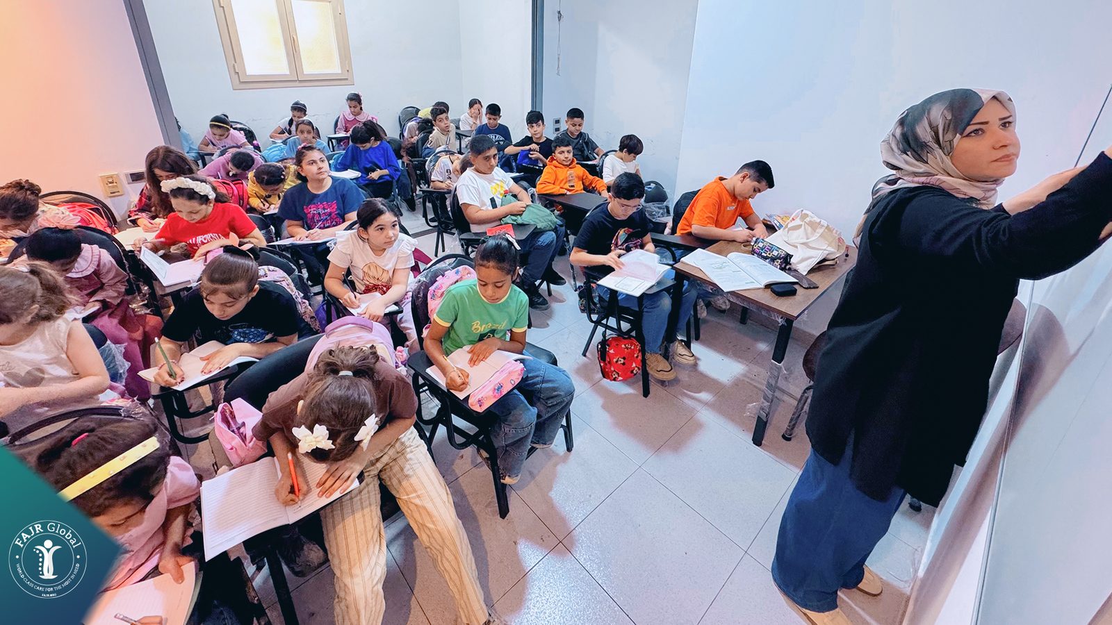 A teacher walking between rows of students