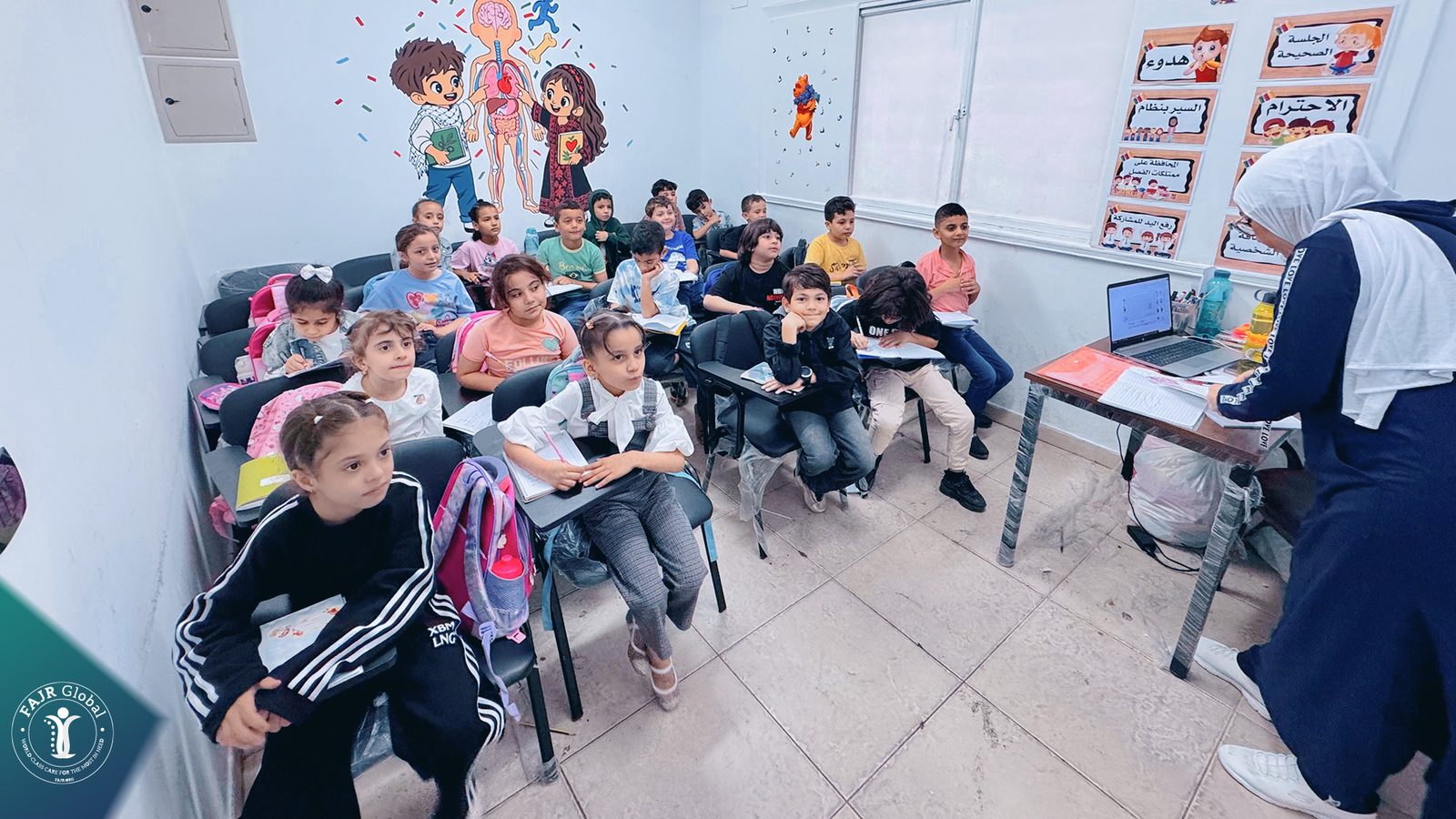 A teacher with a class of young students