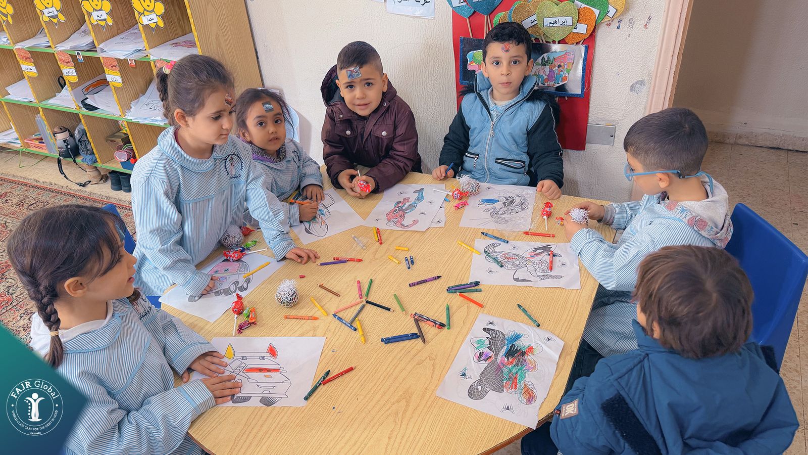 Children colouring pictures together in a classroom