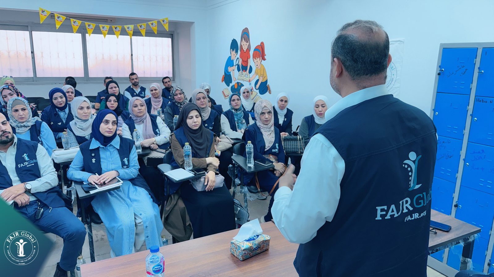 A FAJR Global trainer addressing a full room of staff during the child protection workshop in Egypt
