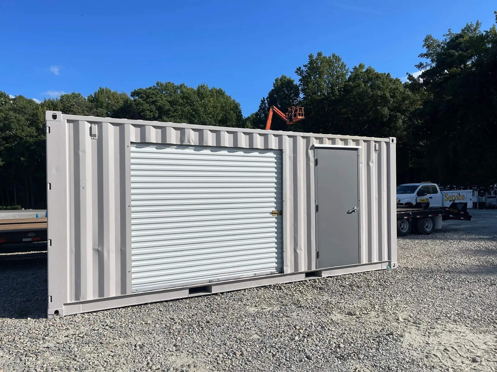 Modified shipping container with roll-up door and window