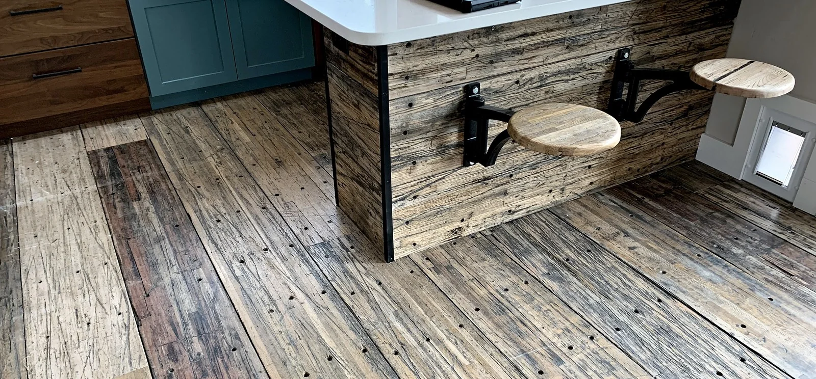 Kitchen island and flooring in reclaimed hardwood.