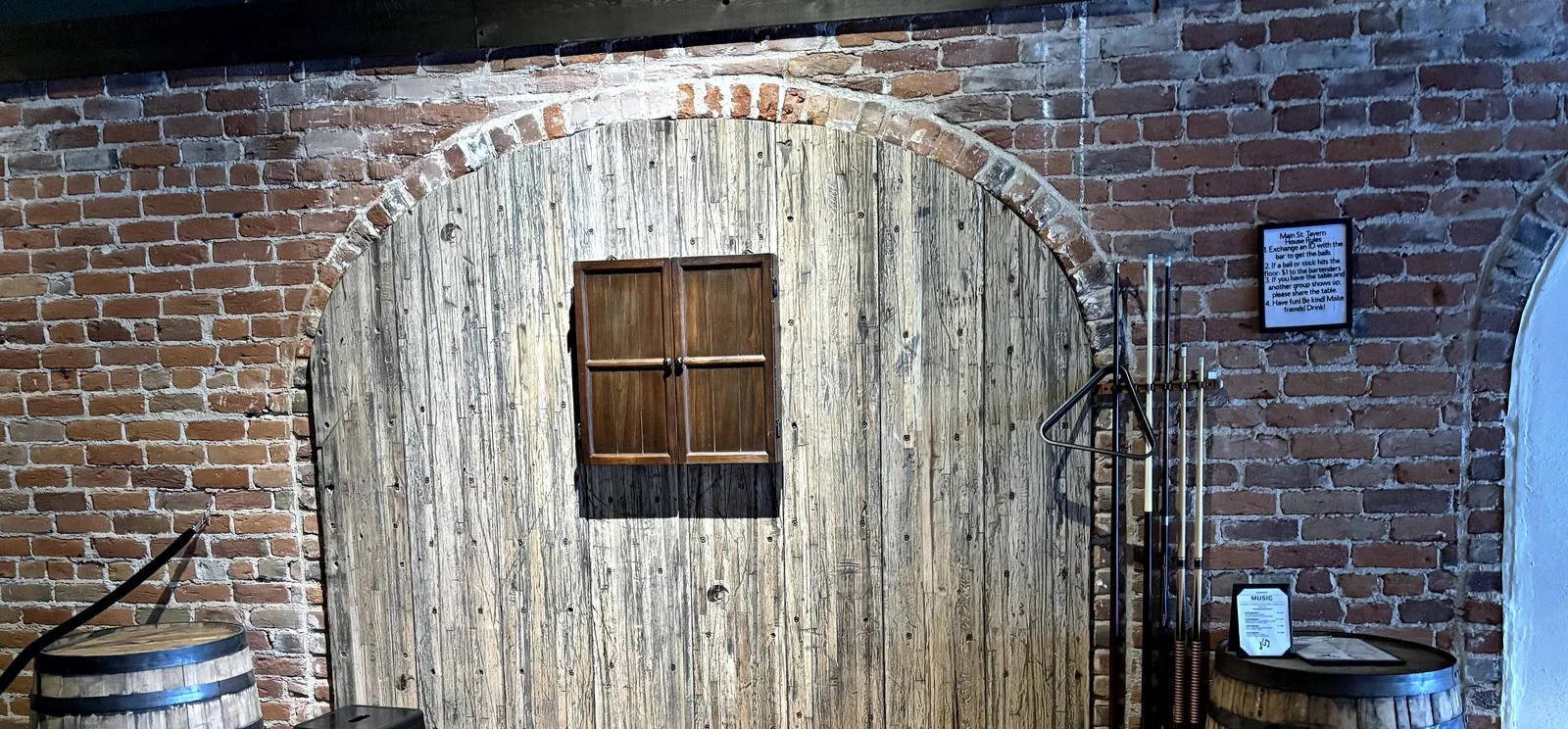 Arched accent wall finished in reclaimed hardwood.
