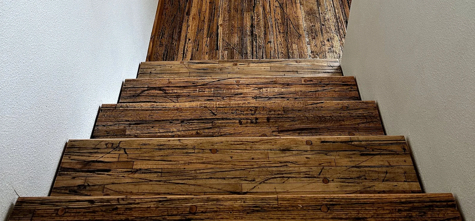 Staircase with reclaimed hardwood treads.