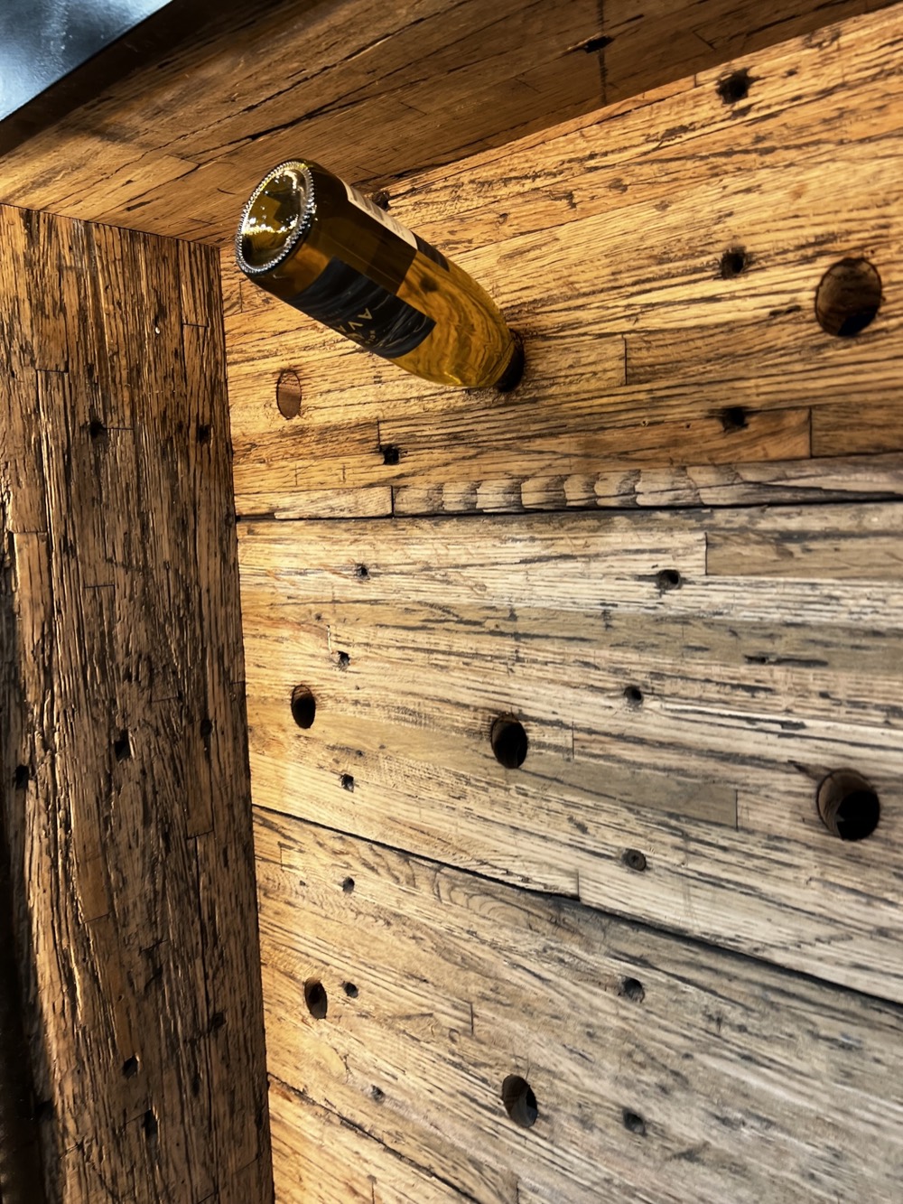 Wine display shelving built from reclaimed hardwood.