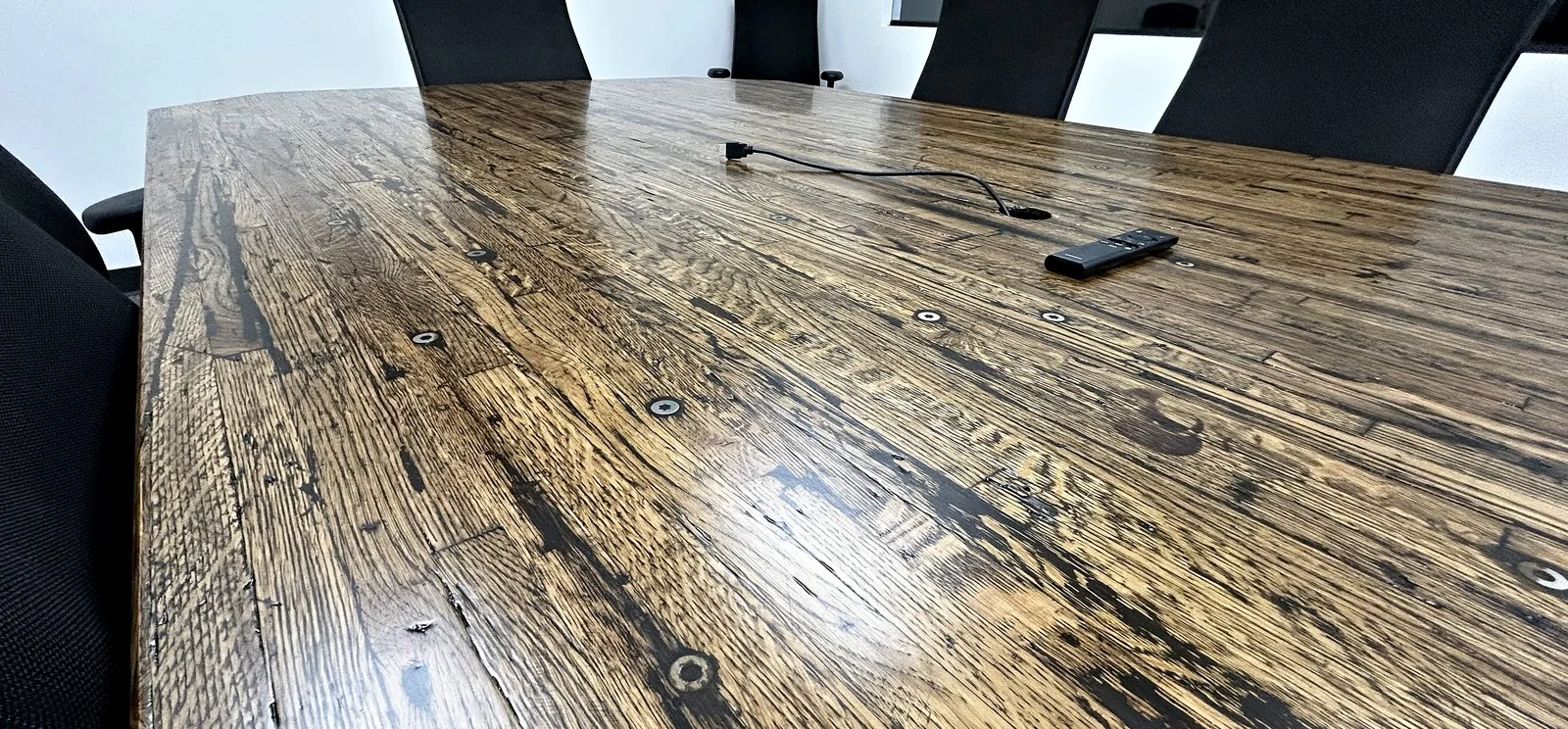 Conference table with a reclaimed hardwood top.