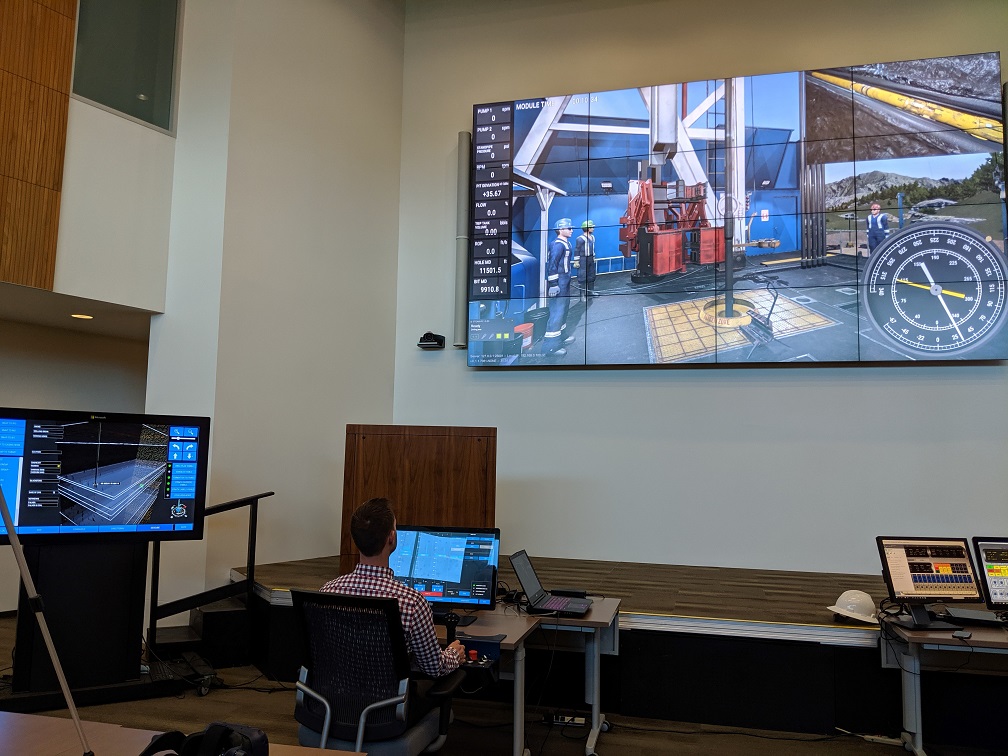 Operator rehearsing a drilling plan across live simulator displays