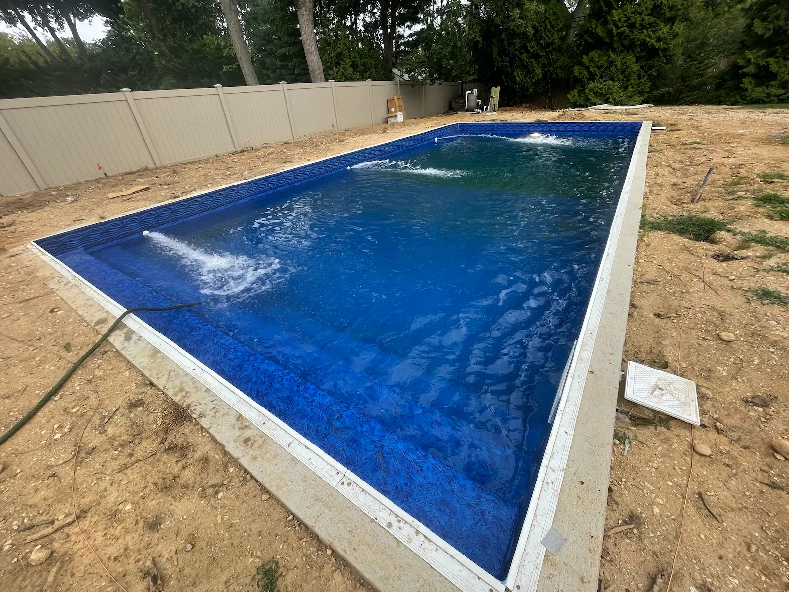 Pool renovation in progress with new blue liner and water features on Long Island, NY.
