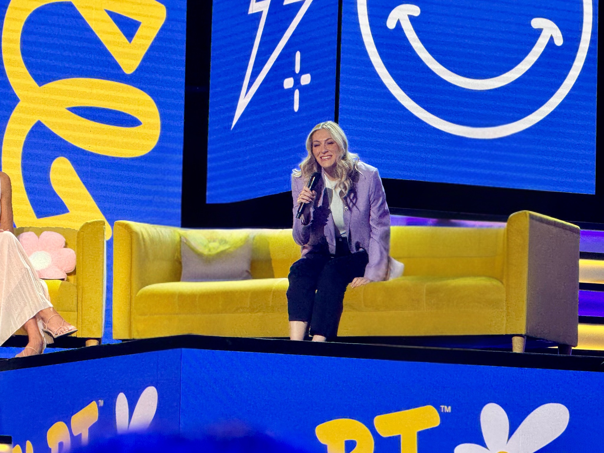 Micaela Schuffman speaking onstage at a consumer brand event