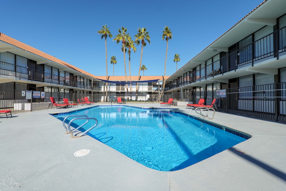Pool with apartment building around it