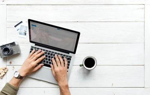 Employee hands typing on laptop