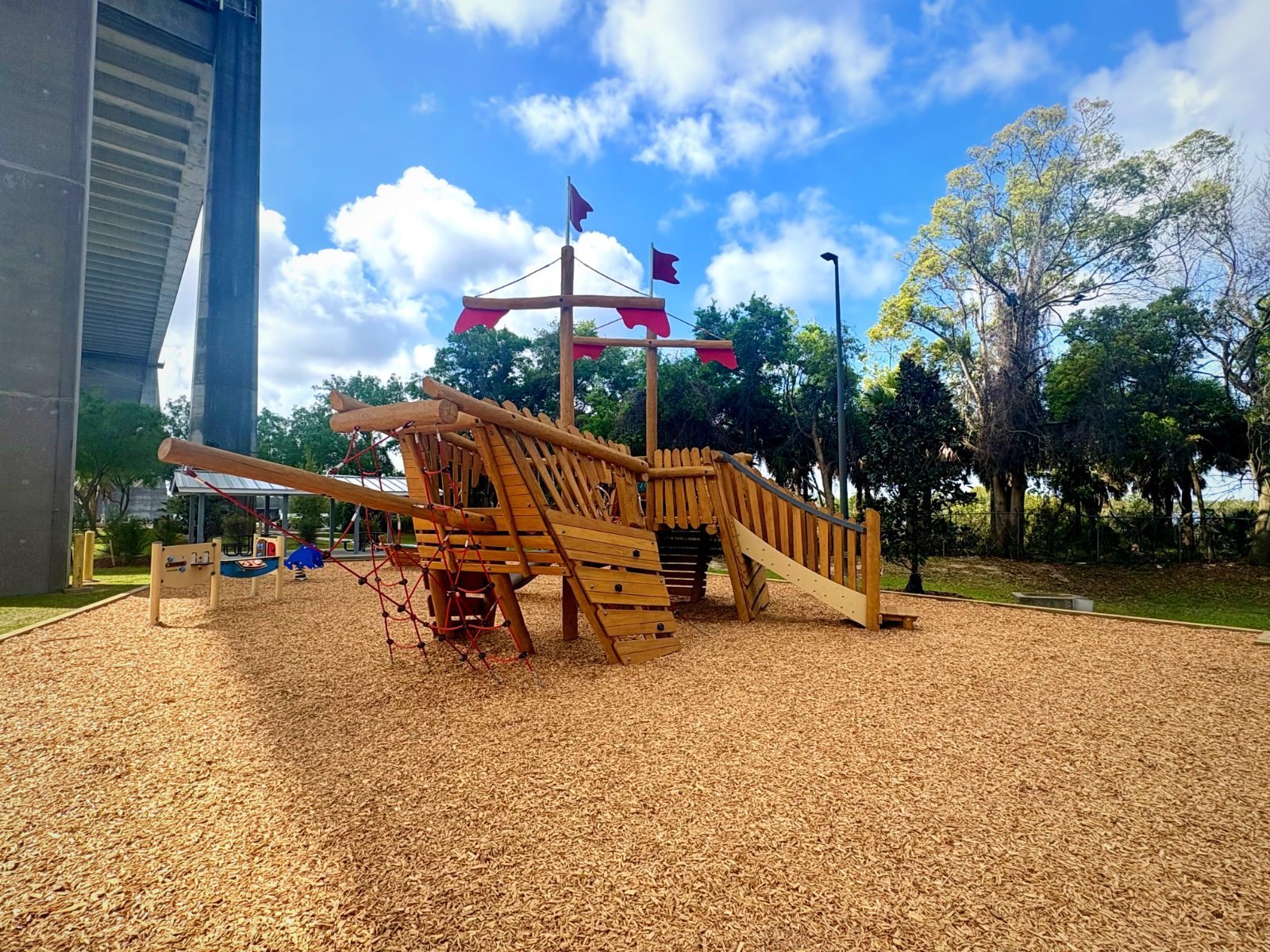 Custom-fabricated timber pirate ship play structure installed at a Florida waterfront park