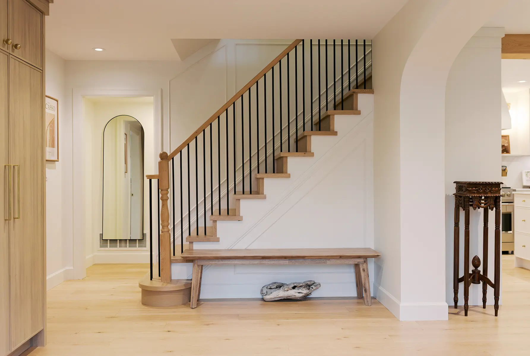 Entry staircase with oak treads, black balusters and a built-in bench, Pemberton Heights renovation