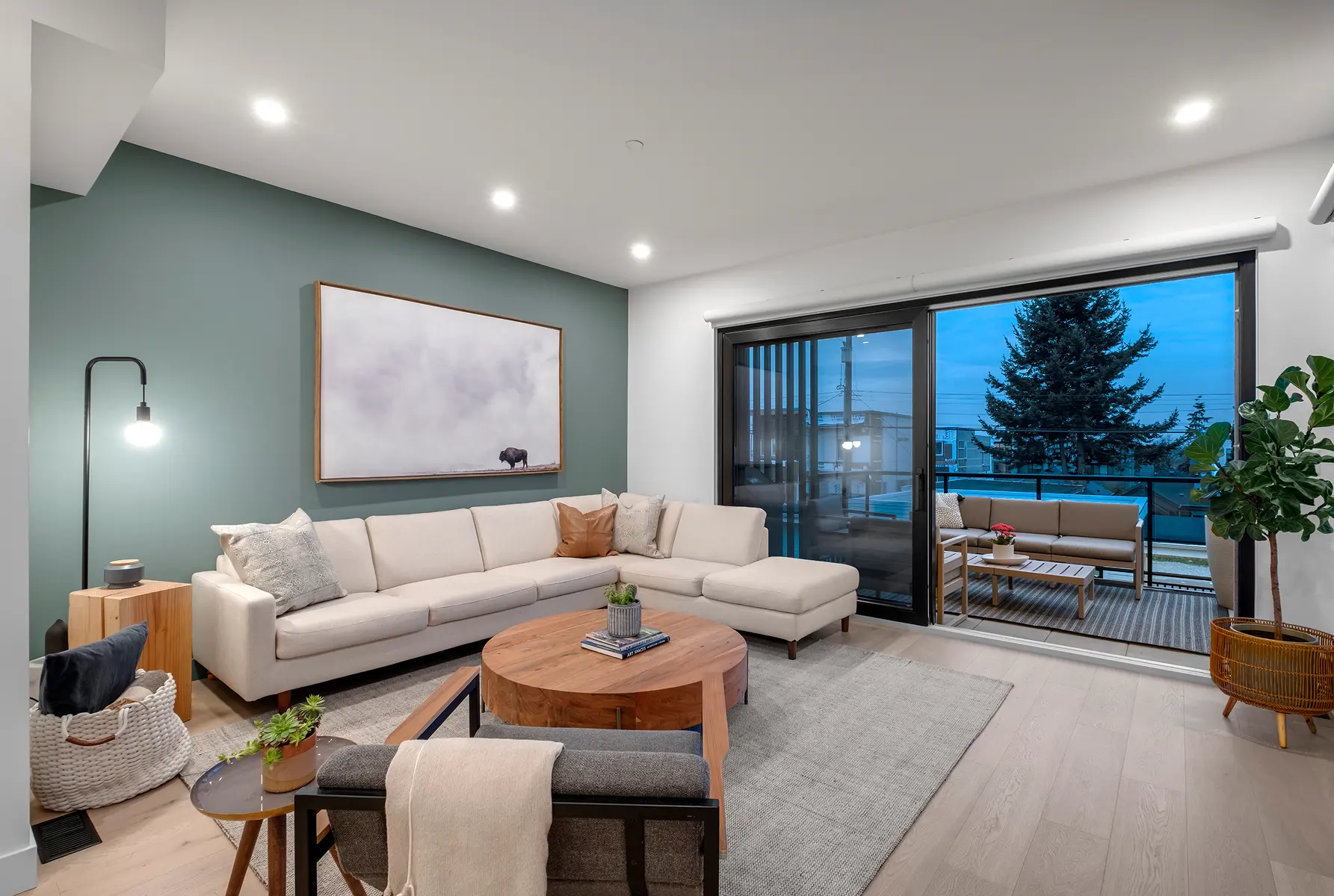 Living room with sectional sofa and sliding doors to the balcony, 4th Street duplex in North Vancouver