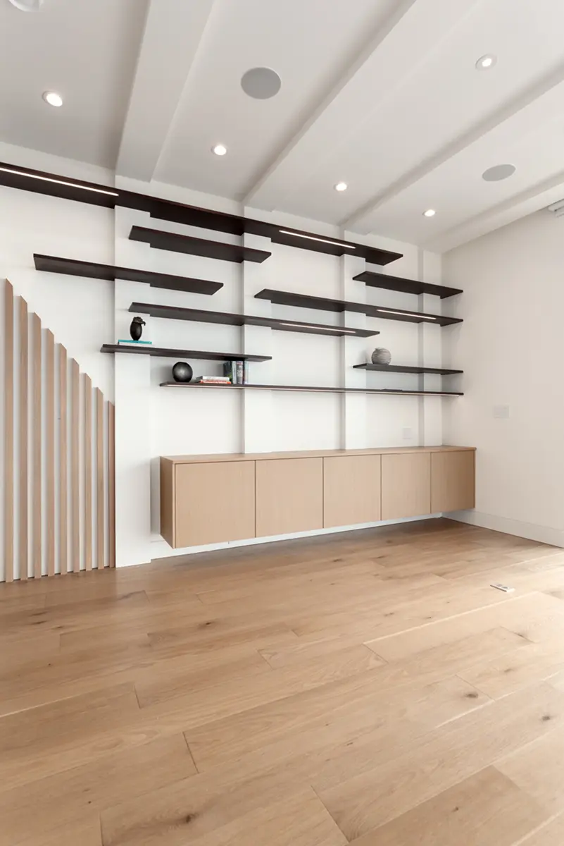 Slatted oak wall detail with floating black shelves and built-in cabinetry, Folkstone Way rebuild