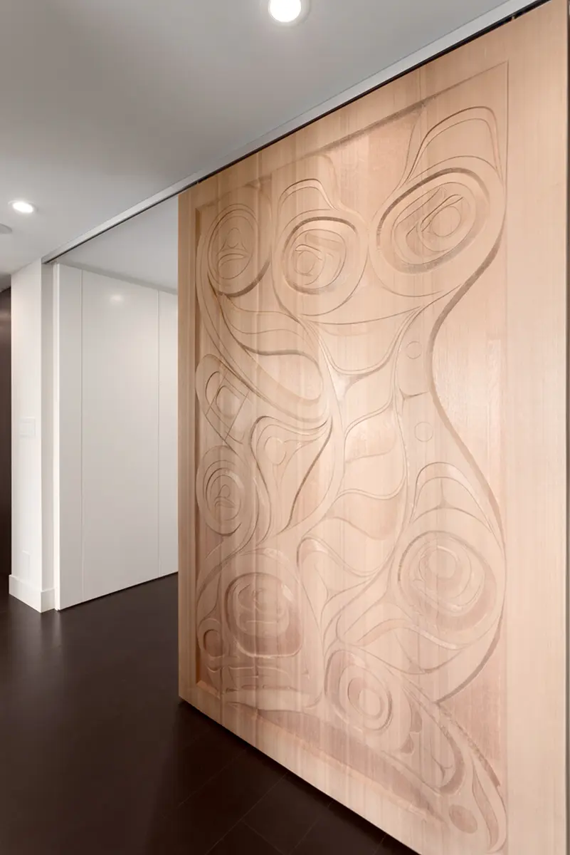 Carved wood panel by artist Rande Cook at the base of the stairs, Folkstone Way rebuild