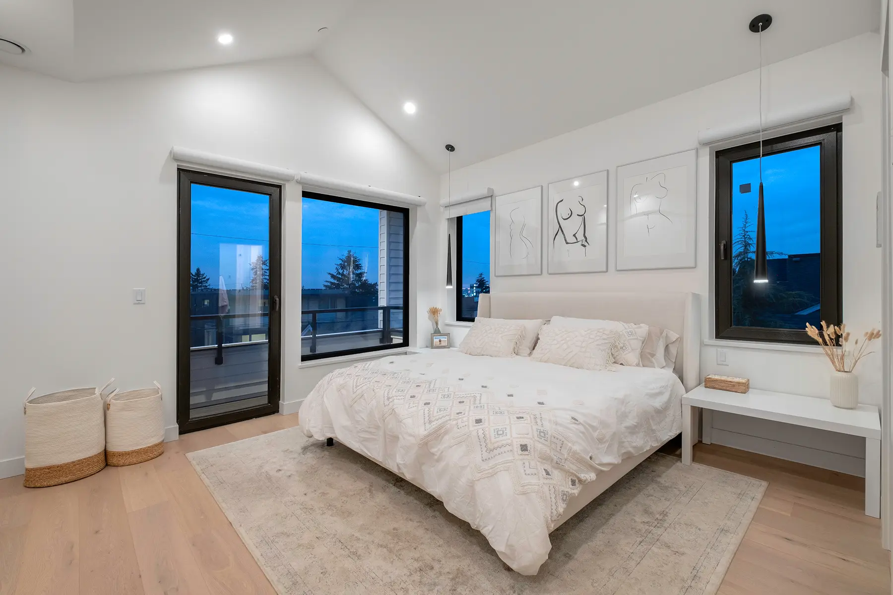 Primary bedroom with vaulted ceiling and large windows, 4th Street duplex