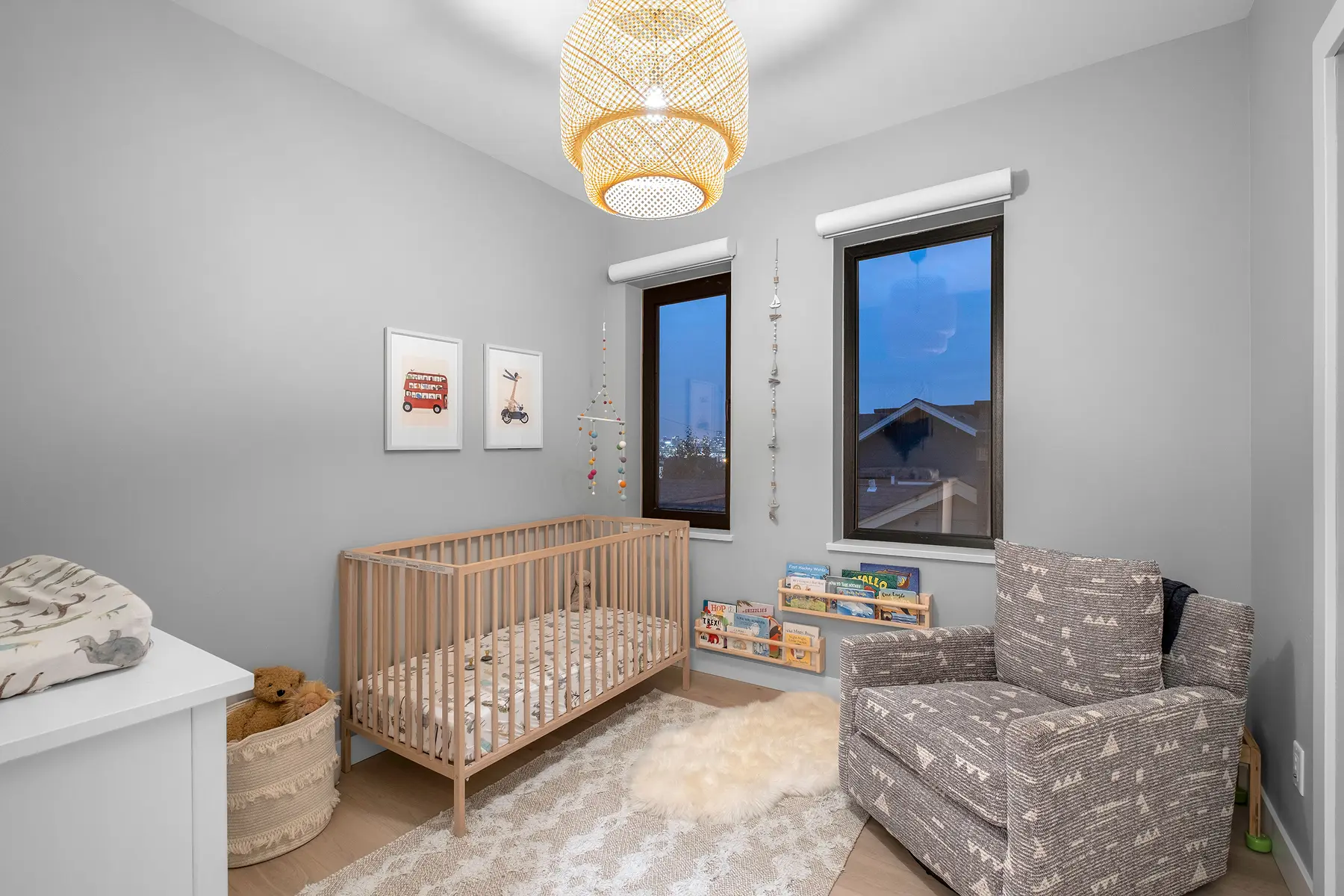 Child's bedroom with a wooden crib and woven pendant light, 4th Street duplex