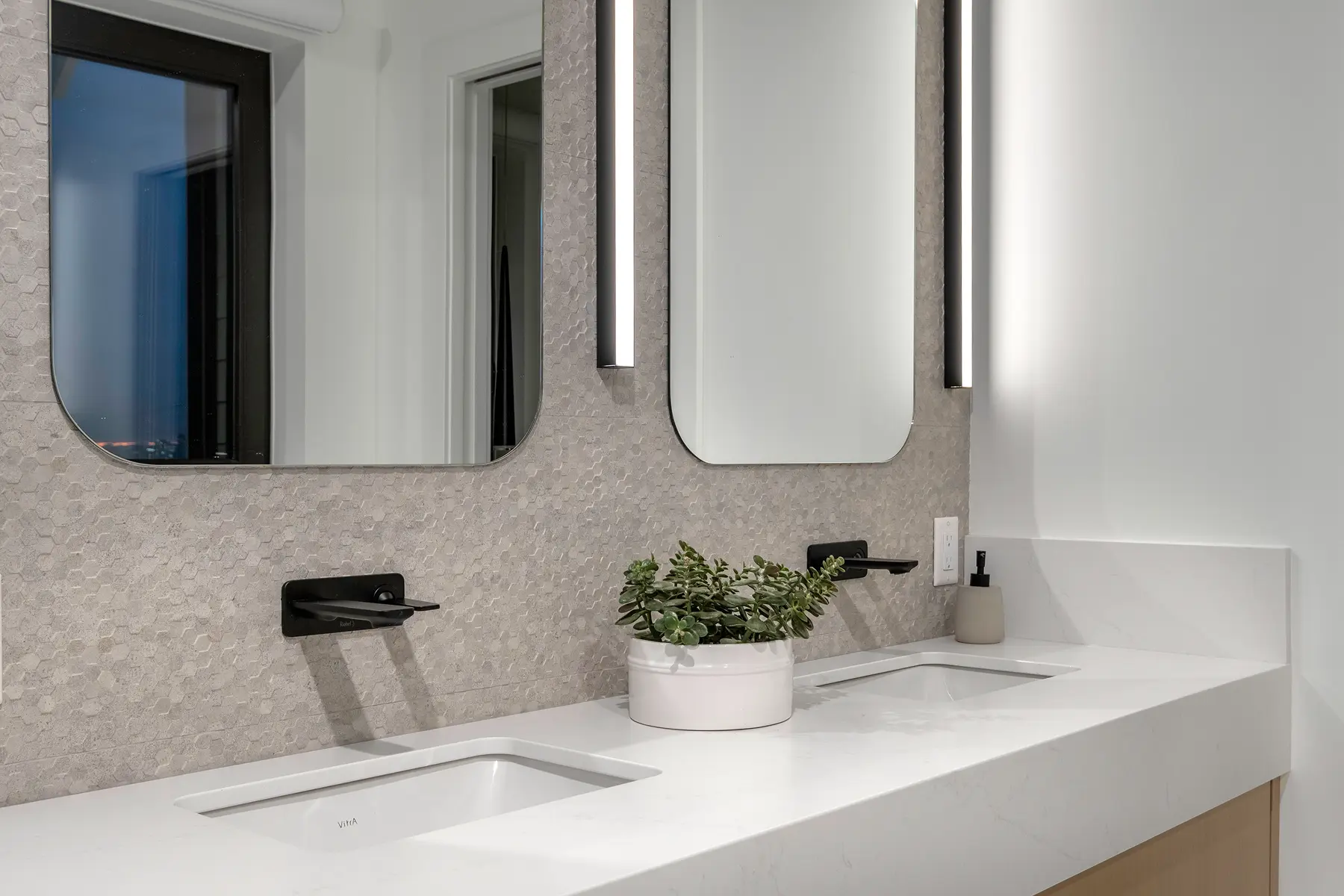 Double sink vanity with matte black fixtures and hexagon tile backsplash, 4th Street duplex
