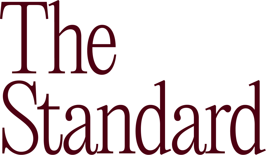 Text logo with 'The Standard' in large serif font and dark burgundy color.