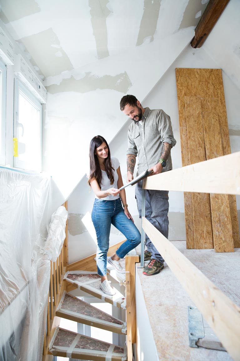 Couple reviewing renovation plans together at home