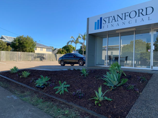 Two men outside the original Stanford Financial shopfront office