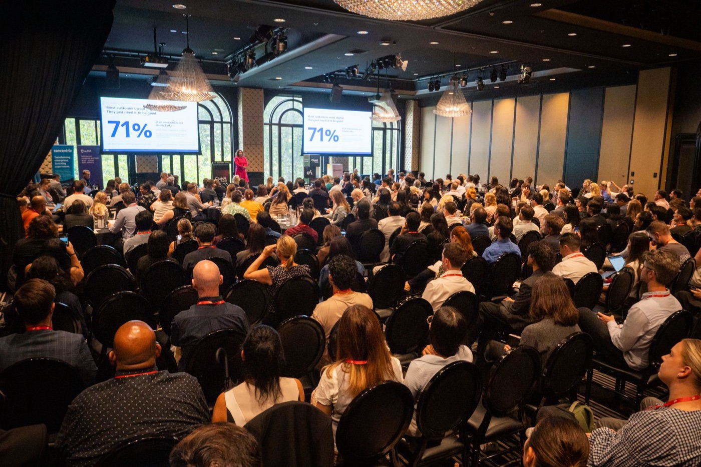 A keynote speaker presenting customer research to the CustomerTech World audience
