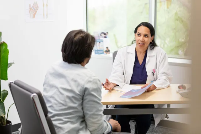 Consultant reviewing a knee X-ray with a patient