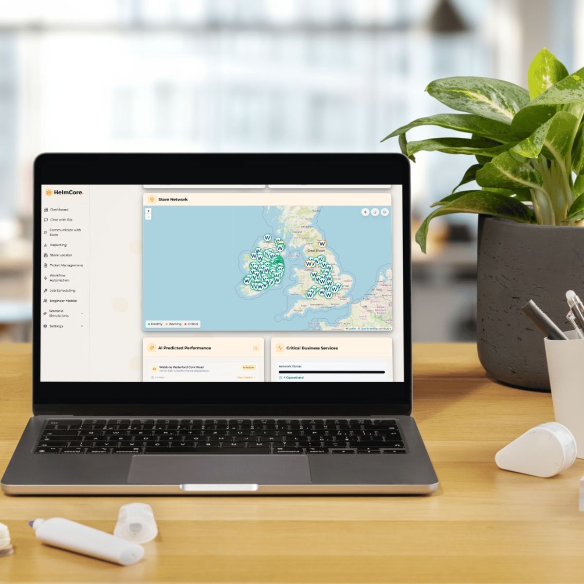Laptop on desk showing the homepage of helmcore platform