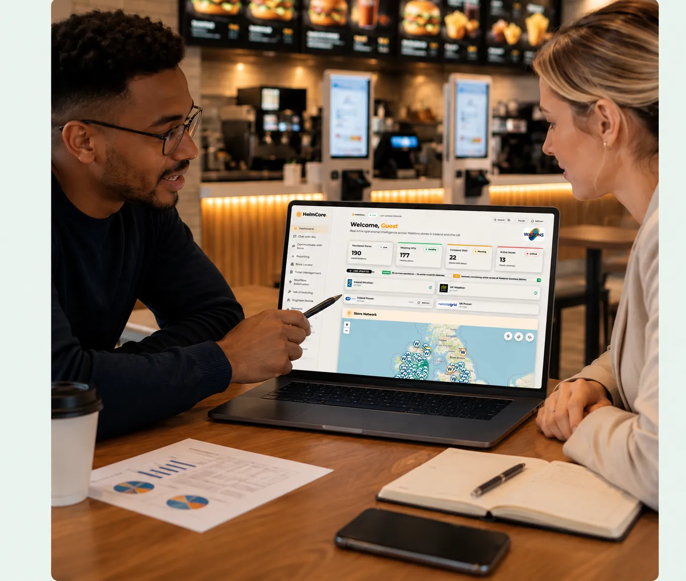 Man and woman at a table in a restaurant, looking at a screen showing their entire estate