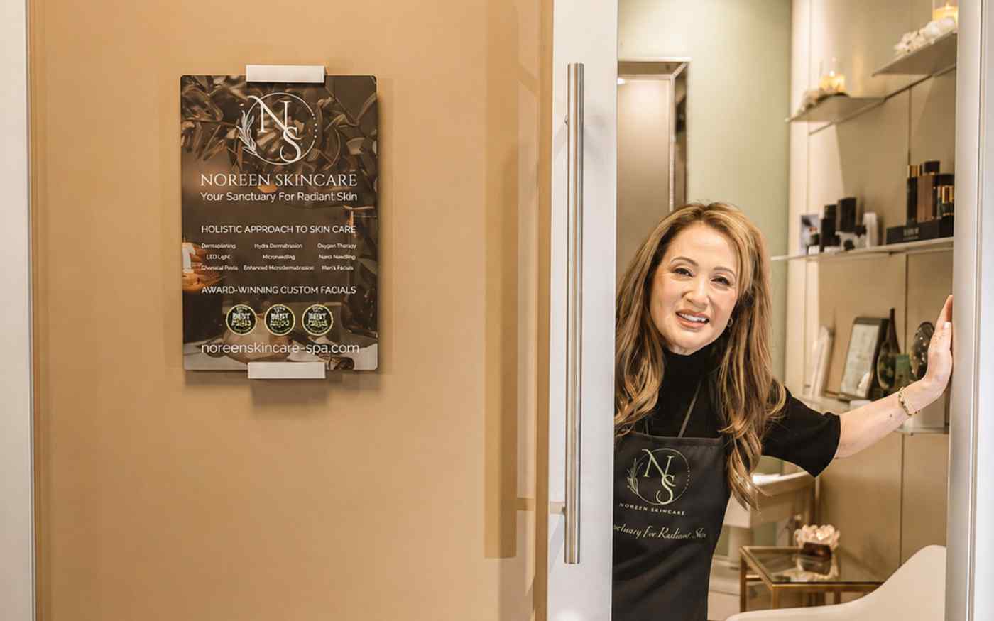 Noreen welcoming clients at her spa's entrance doorway