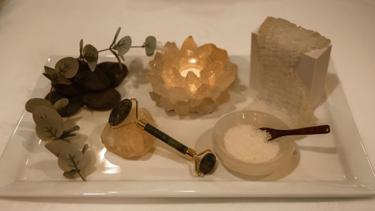 Skincare ritual tray with facial roller, eucalyptus, and bath salts