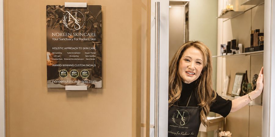 Noreen greeting a client at the treatment room entrance