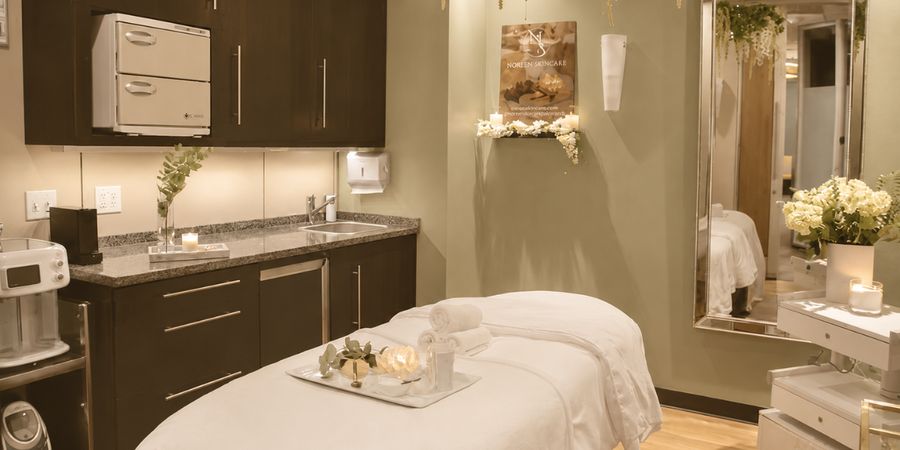 A fully prepared treatment room with candles and fresh florals