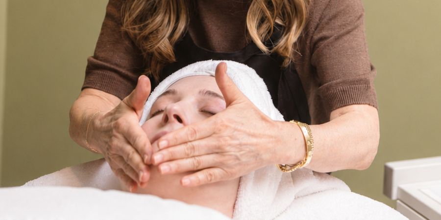 Close-up of Noreen's hands during a facial treatment