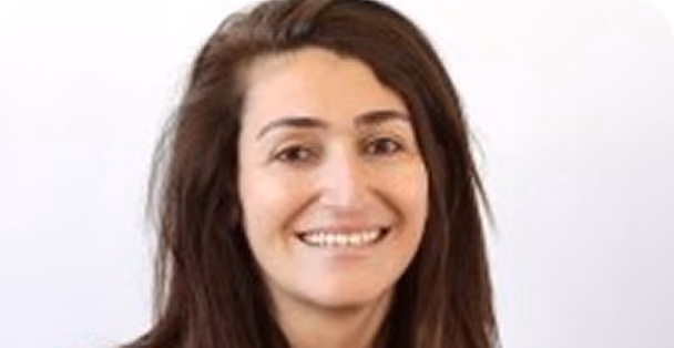 Smiling woman with long brown hair against a plain white background.