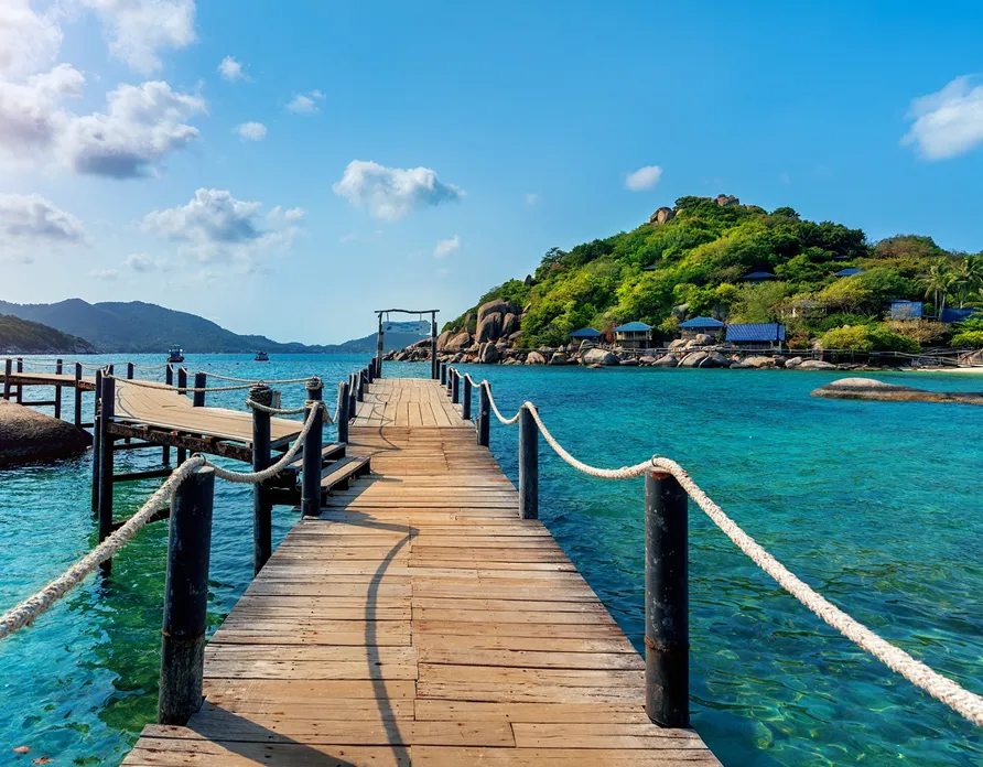 Wooden pier leading to tropical island