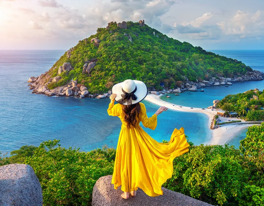Woman overlooking tropical island beach